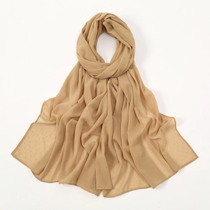 Close-up of light brown pearl chiffon scarf with silver rhinestones and fine stitching