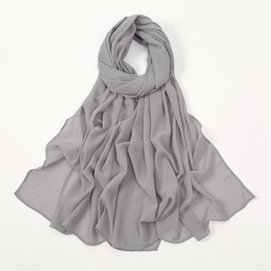 Close-up of grey chiffon hijab with delicate texture and small dot pattern