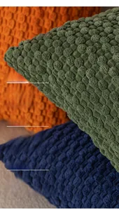 Macro detail of textured bubble pattern fabric on assorted solid decorative cushion covers