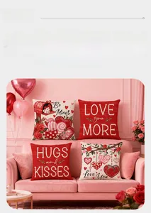 Set of four Valentine's Day pillow covers with LOVE MORE and rose patterns on a sofa