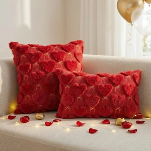 Detail of red plush heart embroidery with gold bows on luxury knit pillow covers