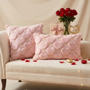 Detail of pink faux rabbit fur pillow cases with heart embroidery for Valentines Day decor