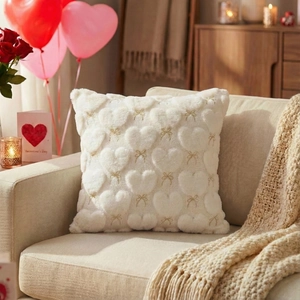 Close-up of heart-embossed faux fur pillowcase with a golden bow for Valentine's Day decor
