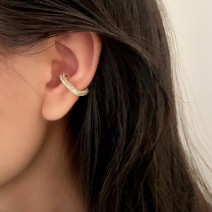 Exquisite gold ear bone clip with micro-set zircons on a model's ear for a stylish look