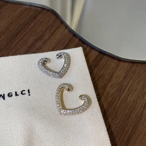 Elegant heart-shaped ear cuffs set with micro-paved cubic zirconia in gold and silver