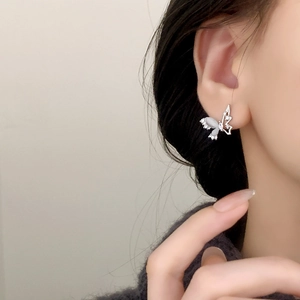 Elegant silver butterfly stud earrings with cat eye stone and cubic zirconia on ear
