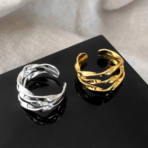 Three-layer twisted geometric open rings in gold and silver finish with mirror-like texture
