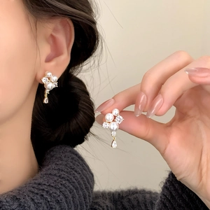 Elegant gold pearl cluster earrings with zircon waterdrop pendant on model