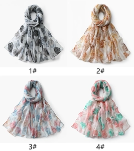 Four different colors of floral print scarves shown in a flat lay grid layout