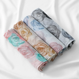 Detail view of four light floral voile scarves in various colors with rose pattern