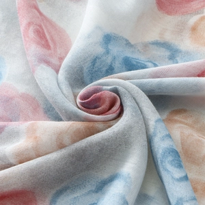 Close-up of lightweight voile scarf fabric with watercolor floral print and soft texture
