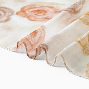 Close-up of lightweight voile scarf featuring vintage rose floral patterns and fine edges