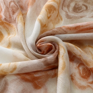 Detailed texture of a soft voile scarf with vintage floral rose print and gauze fabric
