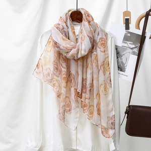 Close-up of semi-transparent voile scarf with brown and orange rose floral prints