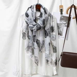 Gray voile scarf with rose print and artistic floral pattern on a light textile
