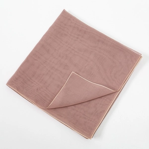 Detail of mercerized cotton scarf showing delicate beige stitching and breathable fabric