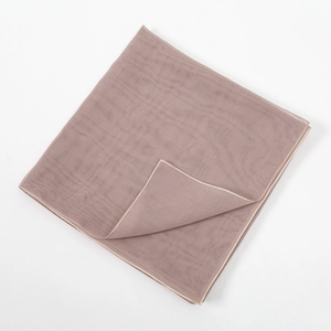 Close-up of lightweight mercerized cotton scarf showing fine texture and hemmed edges