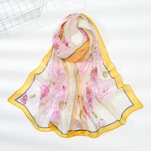 Macro detail of lightweight floral chiffon scarf with rose print and yellow edges