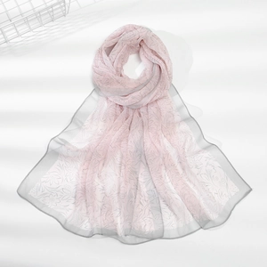 Detail of pink chiffon scarf featuring floral prints and delicate grey rolled edges