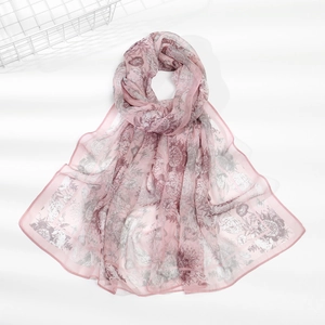 Detail of pink floral print chiffon scarf showing lightweight fabric and hemmed edges