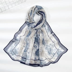 Close-up of leopard floral chiffon scarf showing semi-transparent fabric and navy edges