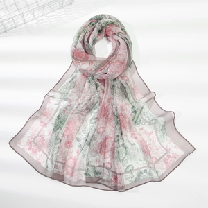 Detail of floral chiffon scarf with elegant pink and green prints and soft shadow texture