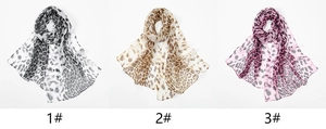 Detailed view of lightweight leopard print scarves in gray, brown, and purple colorways