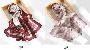 Close-up of wine red and lilac printed chiffon scarves with elegant bow patterns
