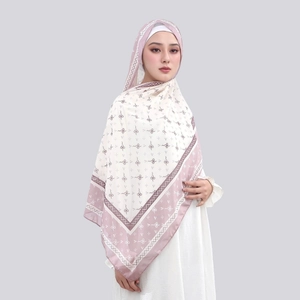 Detail of elegant chiffon hijab with light purple patterns on a creamy white base fabric