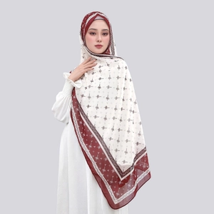 Detail of burgundy and white printed chiffon hijab with geometric pattern for women