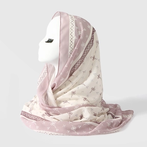 Detail of pink and cream chiffon headscarf featuring sweet bow and geometric print