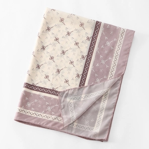 Detailed view of chiffon scarf with pink borders, elegant ribbon patterns, and diamond prints