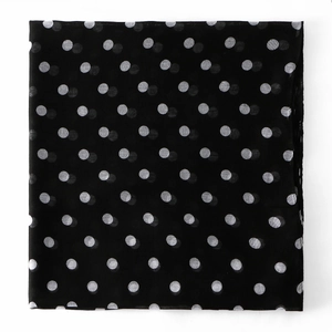 Detail shot of black voile scarf with white polka dots showing fabric texture and finish
