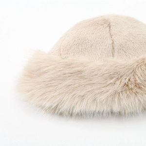 Close-up of beige faux fur winter hat showing plush texture and premium material