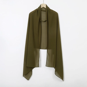 Close-up of dark green chiffon hijab material showing fabric texture and fine hemmed edges