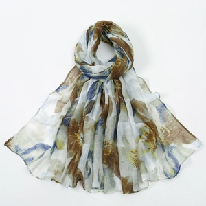 Detail of colorful floral print voile scarf showing soft translucent fabric texture