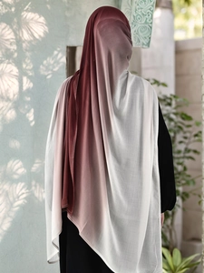 Detail of gradient red to beige breathable modal hijab scarf on a model back view