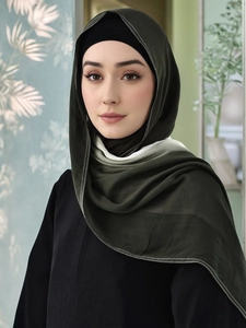 Detail of dark green modal hijab featuring white topstitching and breathable texture