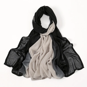 Detail view of the fine stitching and gradient fabric texture on the cotton linen scarf