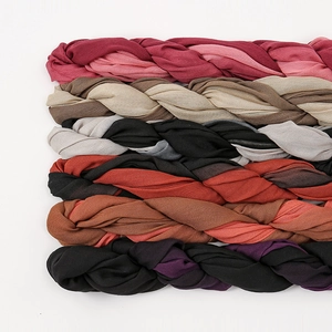 Detail of twisted cotton scarves in various gradient color combinations like burgundy and khaki
