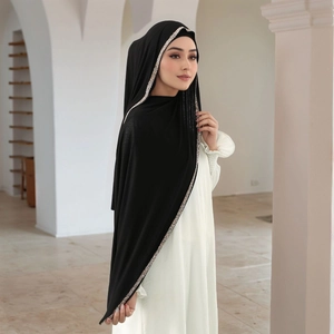 Detail of black Muslim hijab with sparkling silver rhinestone trim on soft fabric