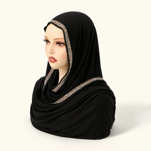 Detailed view of black elastic hijab featuring sparkling gold and silver rhinestone edging