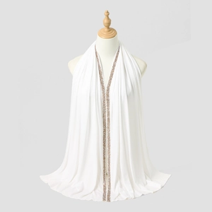 Detail showing champagne sequin bead embroidery on a white chiffon turban headscarf