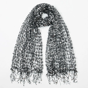 Close-up of black mesh scarf featuring dense silver sequins and elegant tassel edges