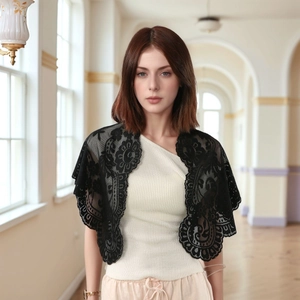 Detail of elegant black floral lace bolero shawl with intricate scalloped edges