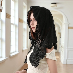 Detail of black lace bridal veil featuring intricate floral embroidery and scalloped edges