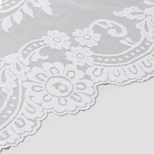 Close-up of intricate white bridal lace with mandala floral patterns and mesh base