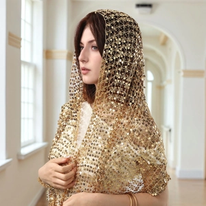 Close-up of golden sequin lace shawl with mesh detail and elegant fringe edges
