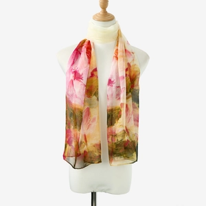 Detail view of pink lotus floral printed chiffon scarf draped on a mannequin