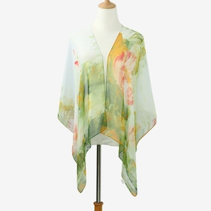 Detail view of sheer lotus print chiffon shawl with elegant floral pattern on light green